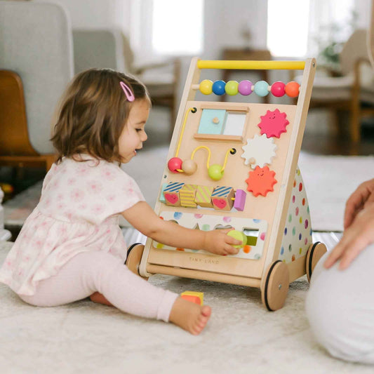 Wood activity walker with bead roller and colorful shape puzzle panel, child playing