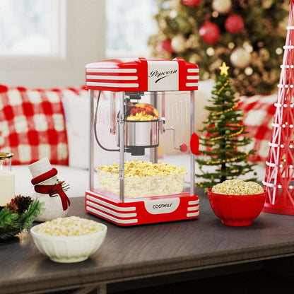 Red theater-style countertop popcorn maker with clear cabinet and stainless steel kettle