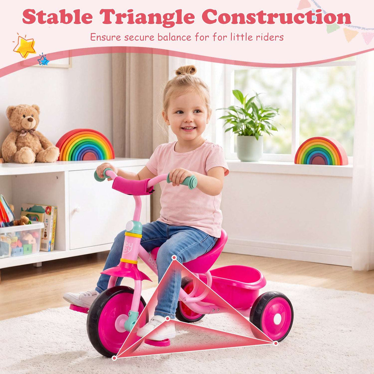 Pink toddler tricycle with storage basket shown with stability triangle graphic