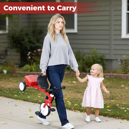Red toddler tricycle with front wheel and black seat, shown with toddler outside