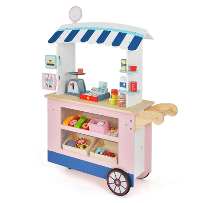 Pink toy market cart with blue and white canopy, wooden push handle, shelves and play accessories