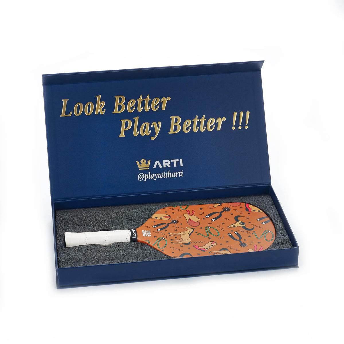 Pickleball paddle in blue gift box with orange patterned face and white grip