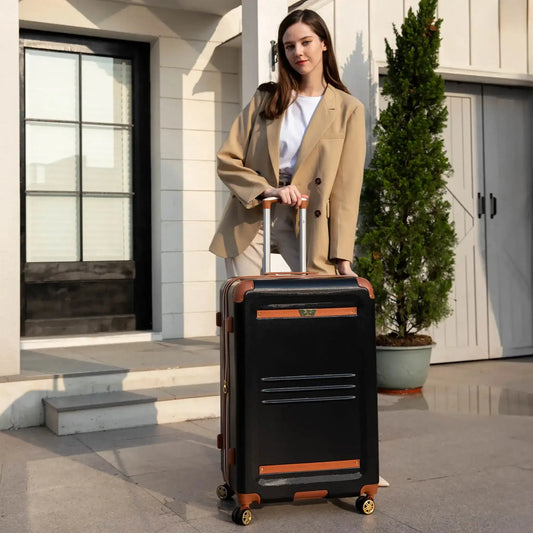 Black expandable rolling suitcase with brown trim, front vent panel, and spinner wheels