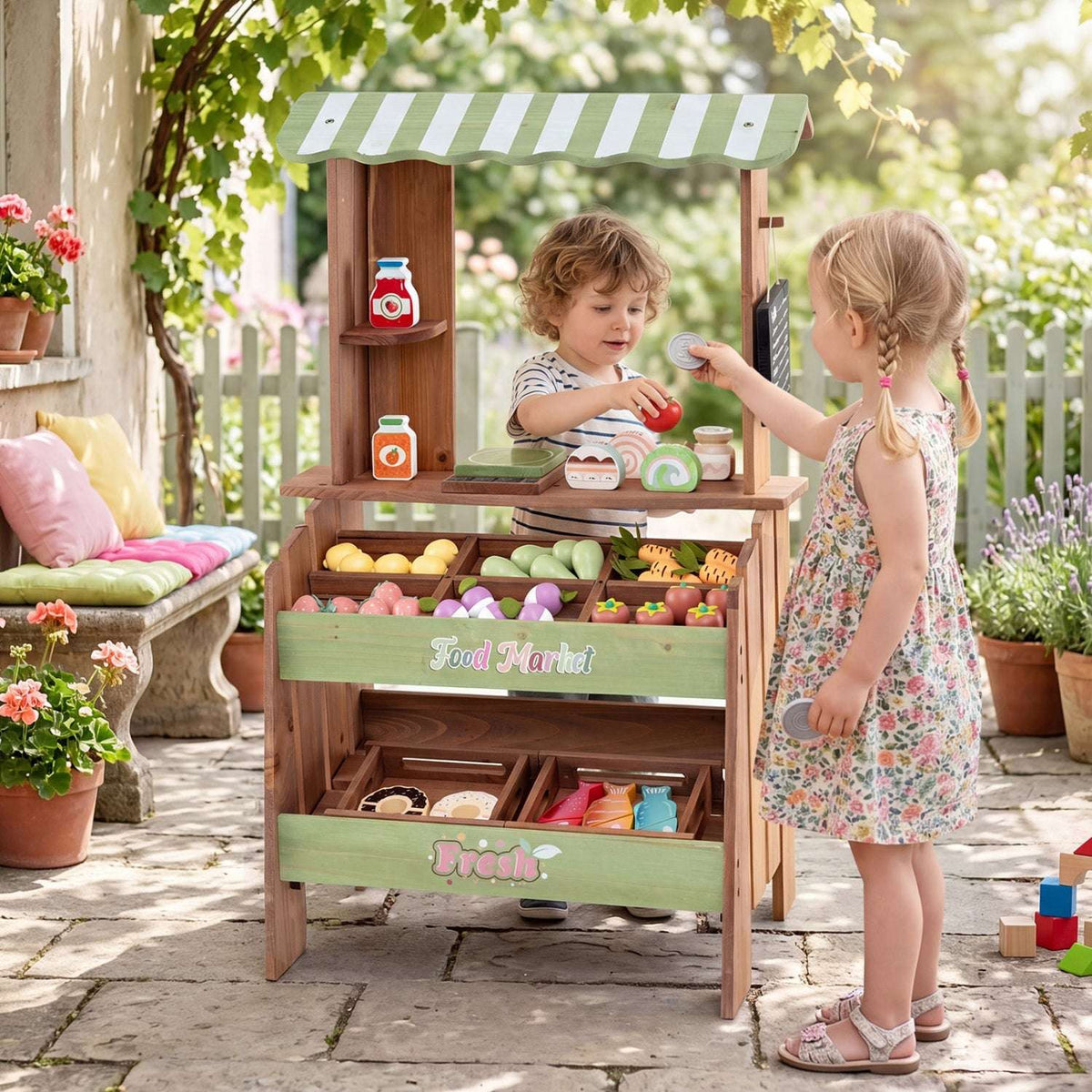 Wooden market playset with striped canopy, produce bins, shelves and play groceries