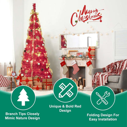 Red pre-lit Christmas tree decorated with gold ribbon and ornaments