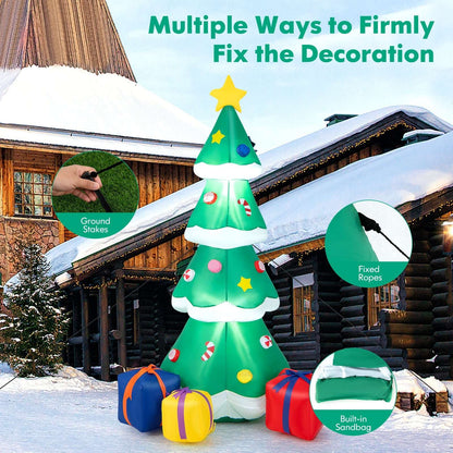 Inflatable Christmas tree with star, ornaments and gift boxes; detail shows ground stakes and securing ropes