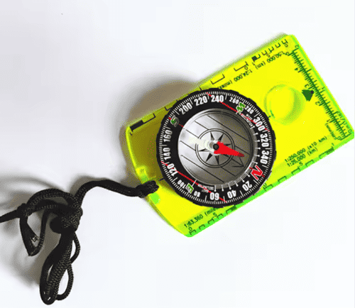 Neon yellow backpacking compass with red needle and integrated ruler, black lanyard