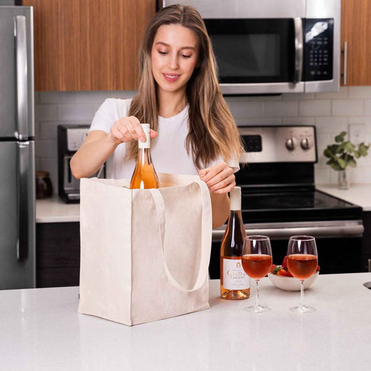 Cream organic cotton canvas wine tote with loop handles, filled with wine bottle