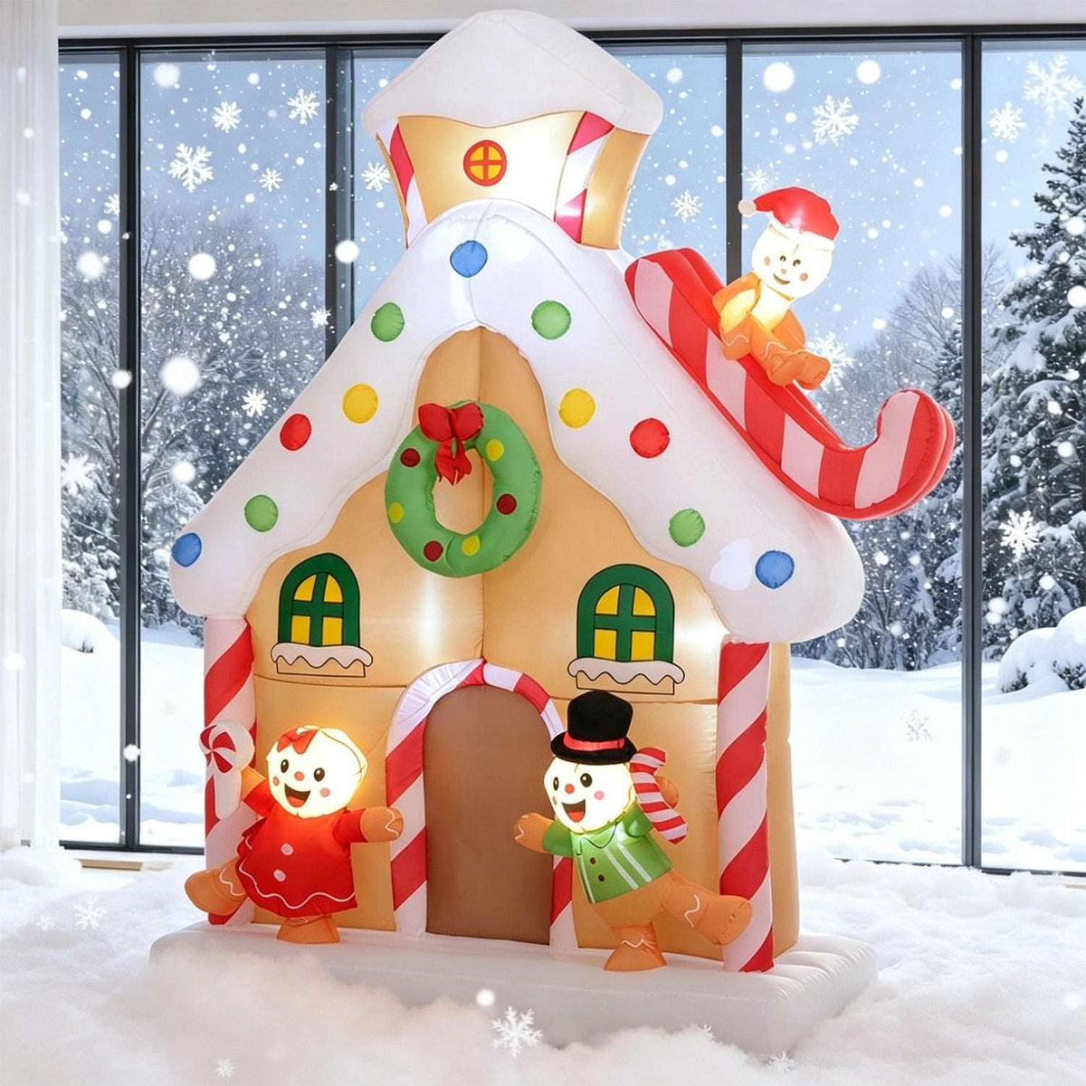 Inflatable gingerbread house with candy-dotted roof, wreath, gingerbread figures and sleigh snowman