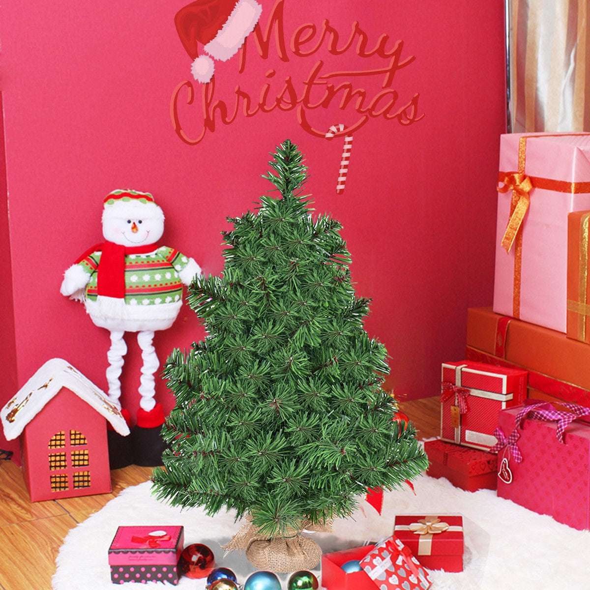 Artificial green Christmas tree with a burlap-wrapped base