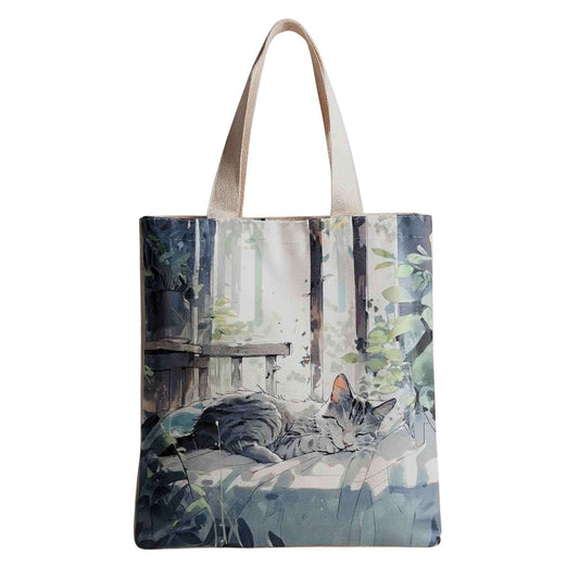 Printed fabric tote bag with cat scene, light top handles, and rectangular shape