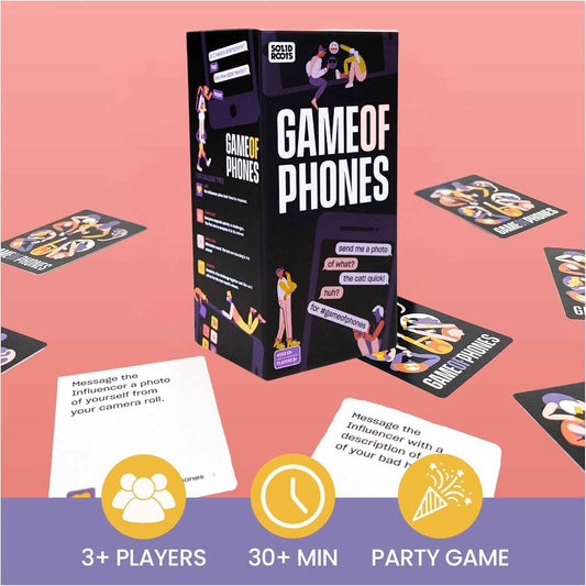 Smartphone card game box with instruction cards and game tiles on a play surface