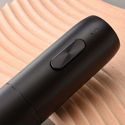 Black rechargeable electric wine opener with an oval control button