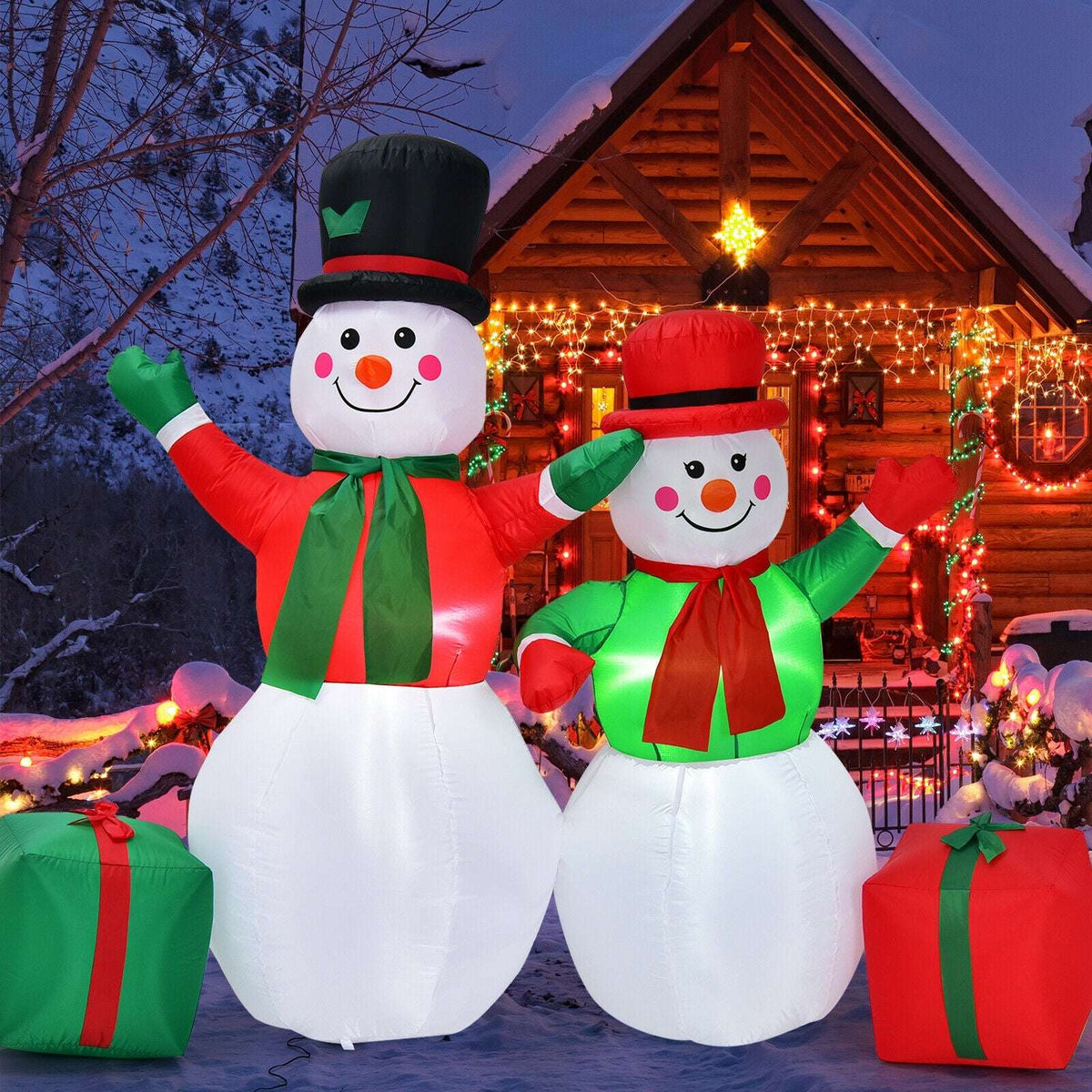 Inflatable snowman pair with red and green outfits, top hats, and gift boxes