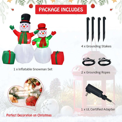 Inflatable snowman set with two figures and gift boxes, plus stakes, ropes, and power adapter