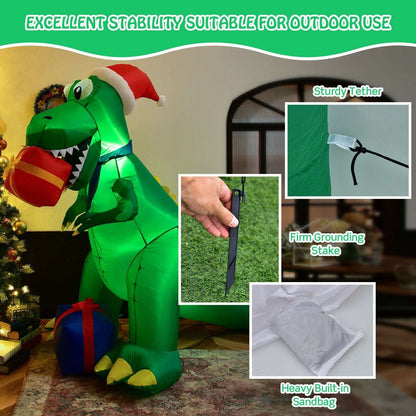 Green Christmas inflatable dinosaur with close-ups of its tether, ground stake, and sandbag
