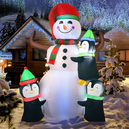 Inflatable snowman and three penguins, shown as a full holiday display
