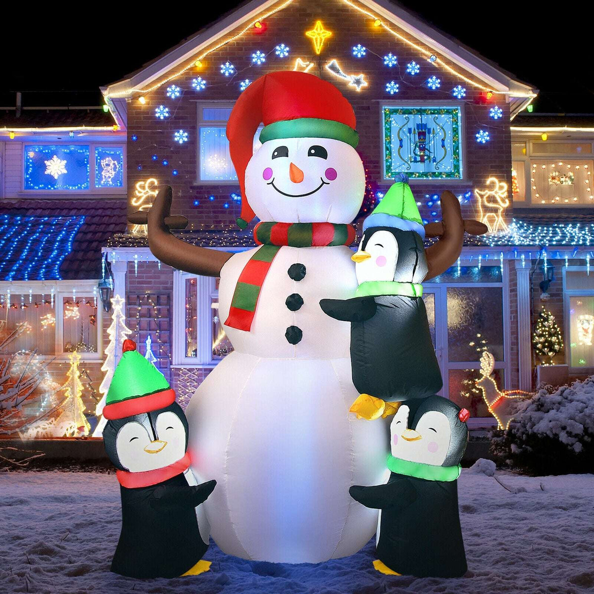 Illuminated inflatable snowman with three penguins in colorful winter hats