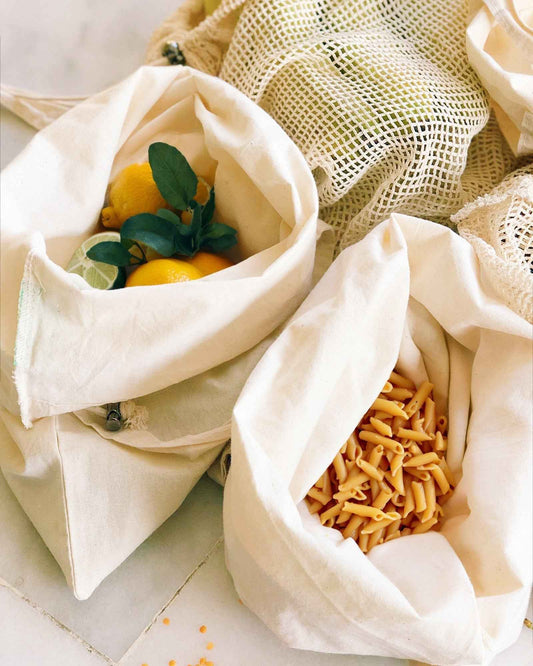 Set of 9 reusable organic cotton tote bags, white, open with vegetables and pasta