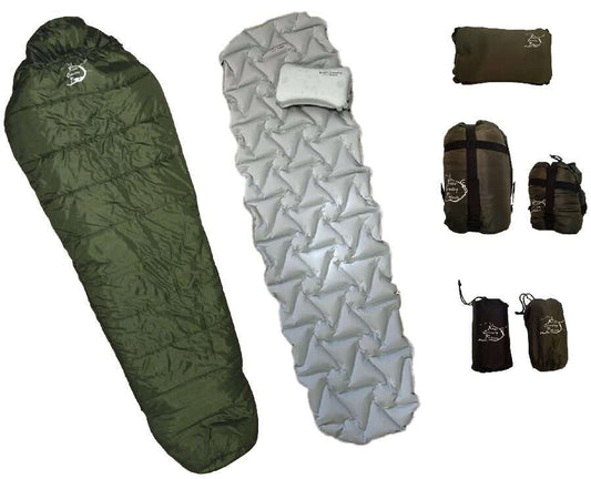Dark green sleeping bag with light gray quilted pad and small pillow, plus storage rolls.