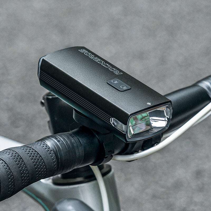 Close-up of bicycle front headlight on handlebars with white front lens