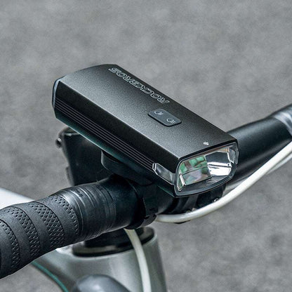 Close-up of bicycle front headlight on handlebars with white front lens