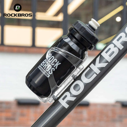 Bicycle water bottle cage holding a clear water bottle on a bike frame.
