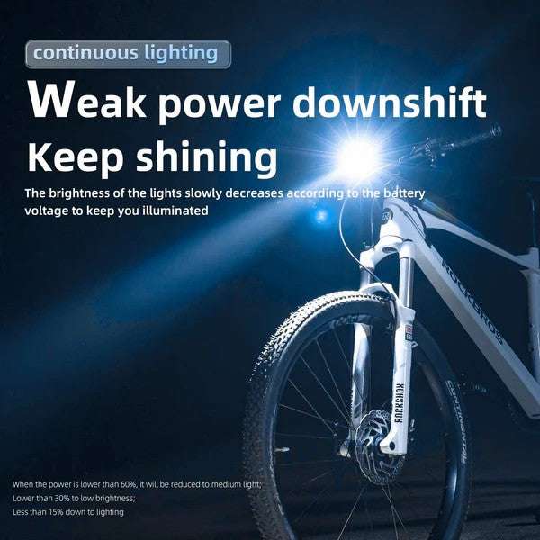 Front bike light mounted near the fork, shining a bright white beam