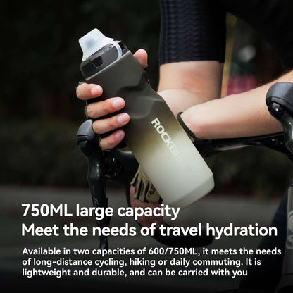 Olive bike water bottle with flip-top lid, held while riding