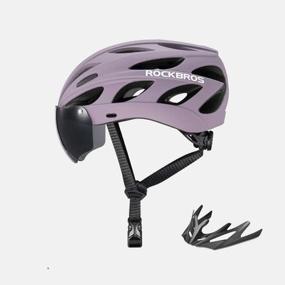 Lilac bike helmet with clear visor and attached goggles, includes extra goggle piece