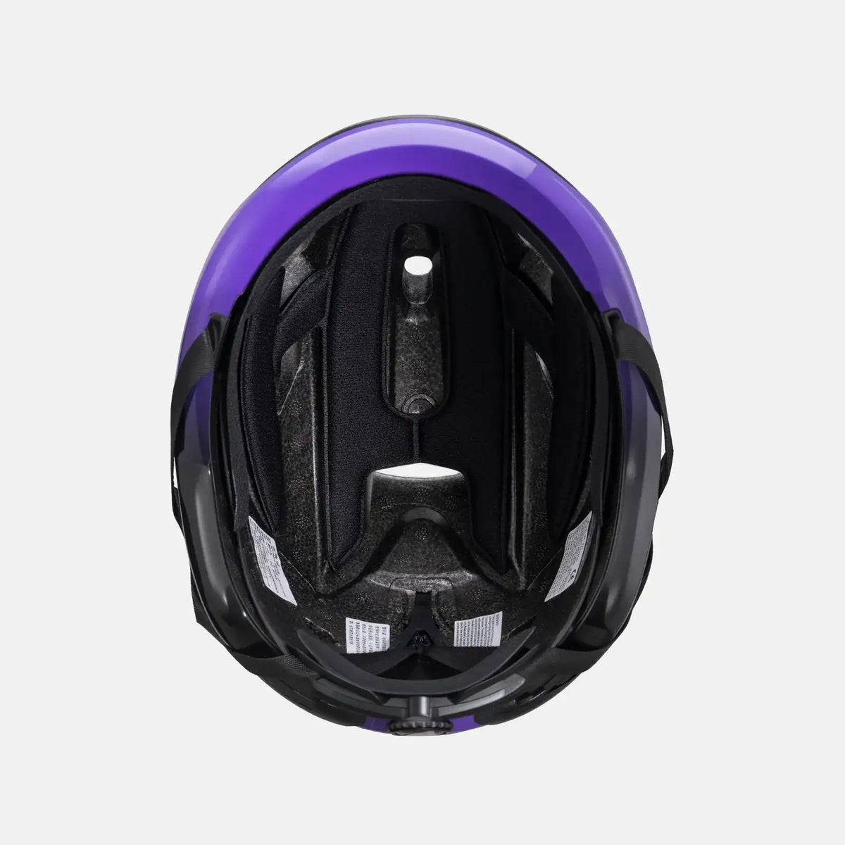 Black-and-purple bike helmet interior with vents and centered adjustment channel.