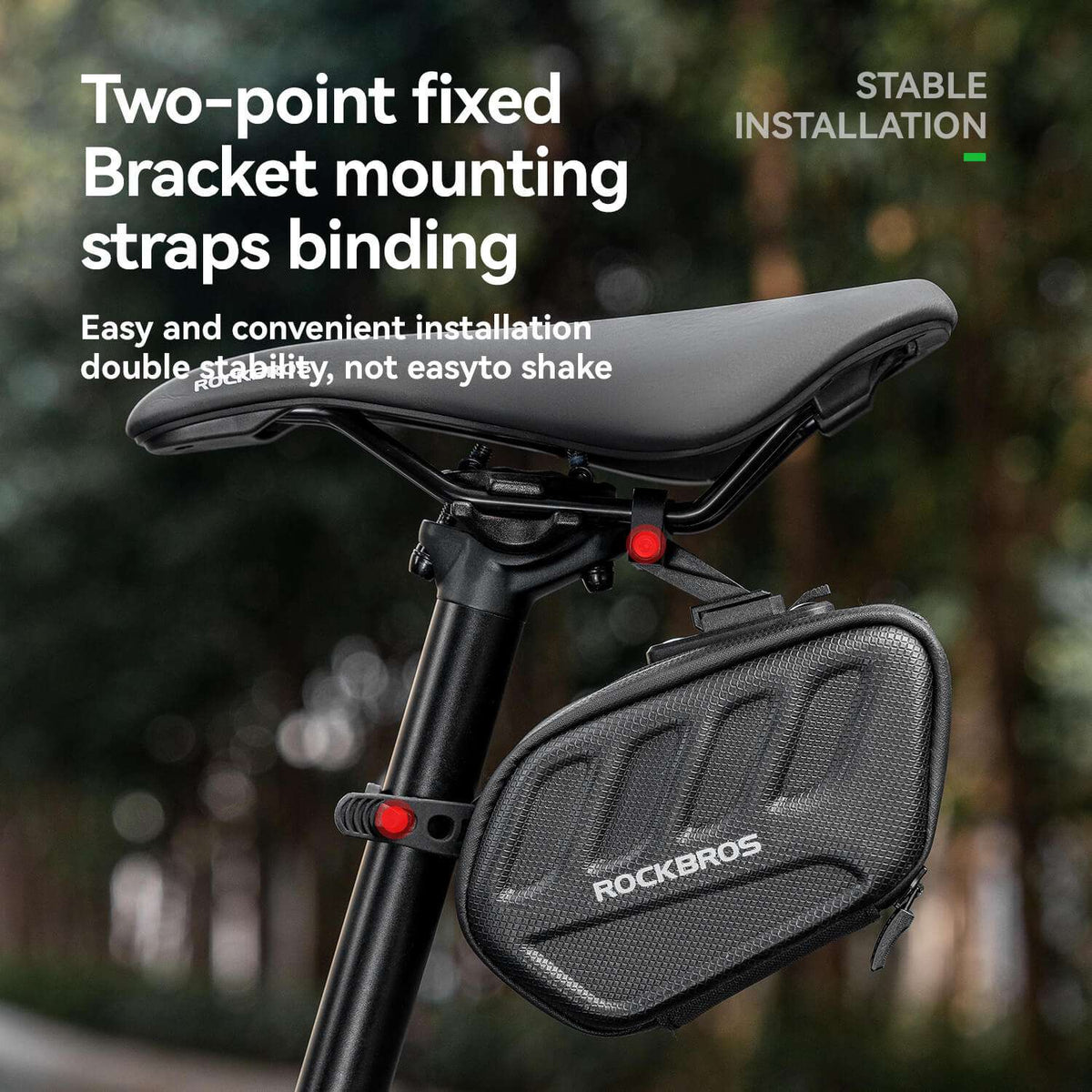 Black bike saddle bag with two-point straps mounted under the seat, red tail light