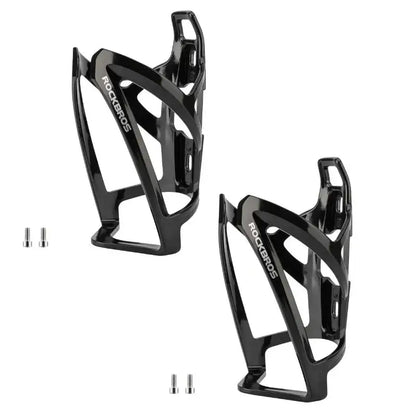 Pair of black bike water bottle cages with mounting holes and cutout sides.