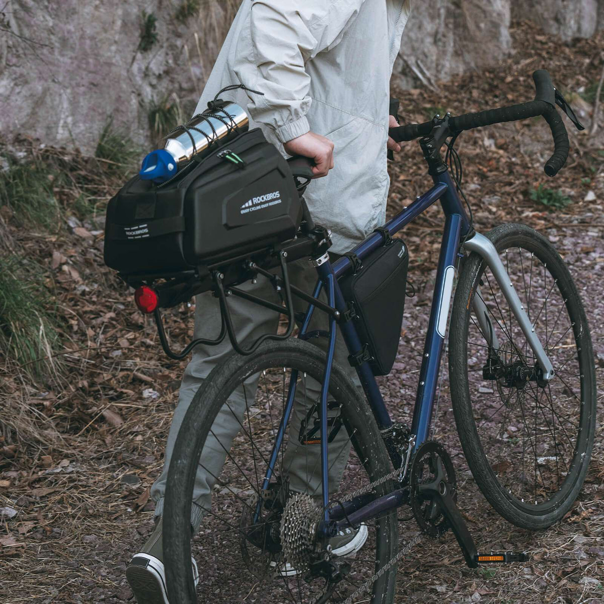 Black hard-shell rear rack bike trunk bag mounted on a bicycle
