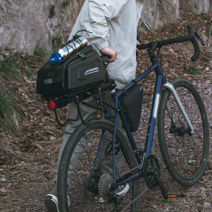 Black hard-shell rear rack bike trunk bag mounted on a bicycle