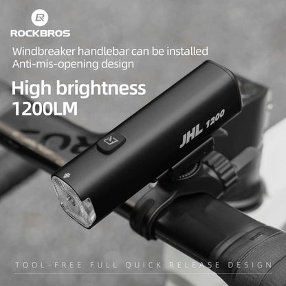 Black bike front light mounted on handlebars with angled front lens