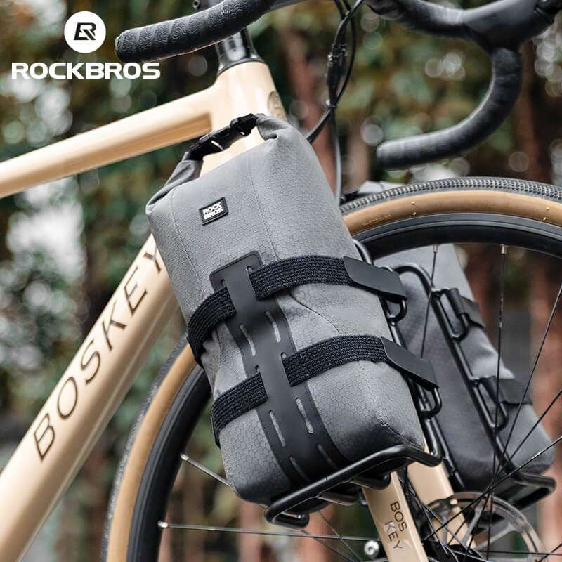 Gray water-resistant front fork rack bag mounted on bicycle fork with reinforced base