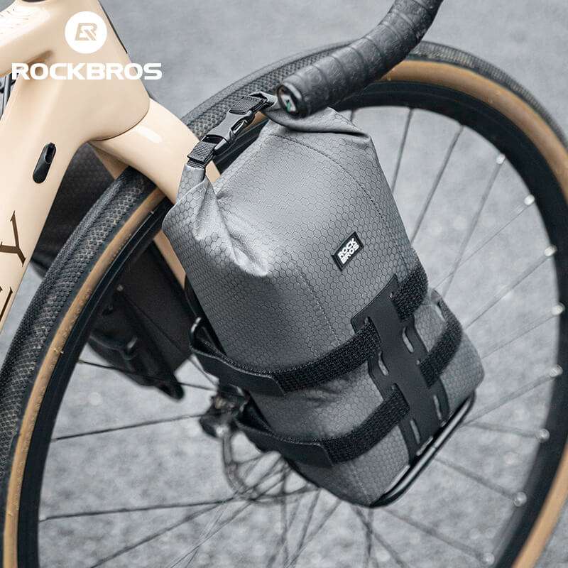 Gray front fork rack bag angled on bicycle fork with black side straps