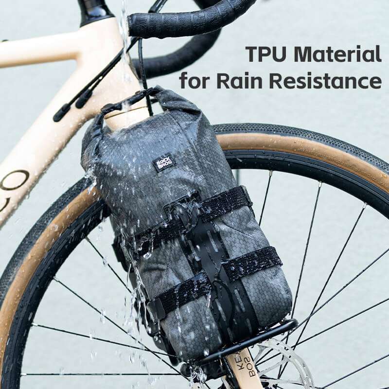 Gray TPU front fork rack bag on bicycle with water-splashing fabric texture