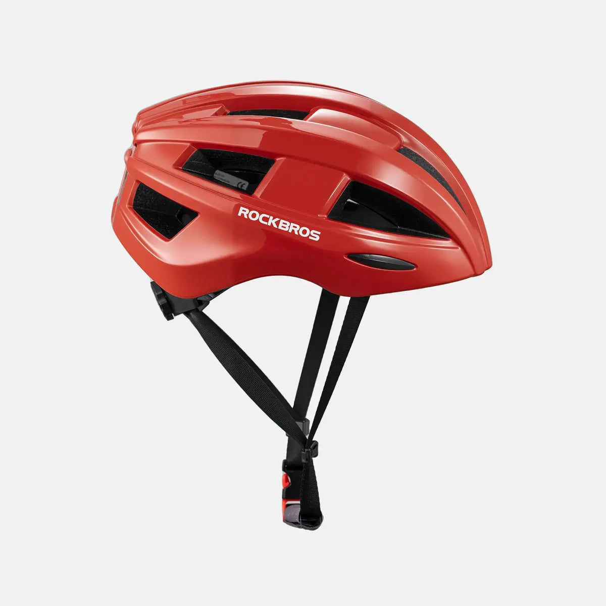Red bike helmet side view with ventilation cutouts and chin strap