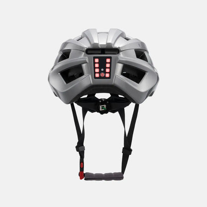 Light gray bike helmet with rear LED light, black straps, and vented shell