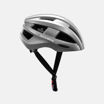 Silver bike helmet with rear LED light, black straps, and vented shell