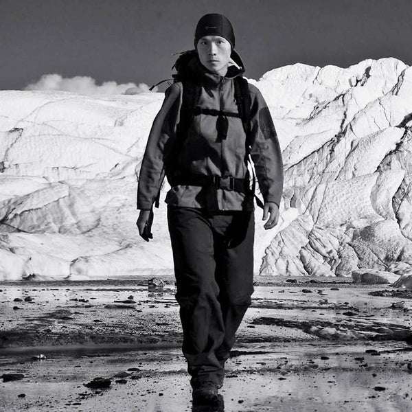 Thermal skull cap liner worn under a hood in cold outdoor conditions
