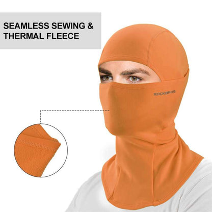 Orange thermal fleece balaclava ski mask close-up with face panel and seam stitching