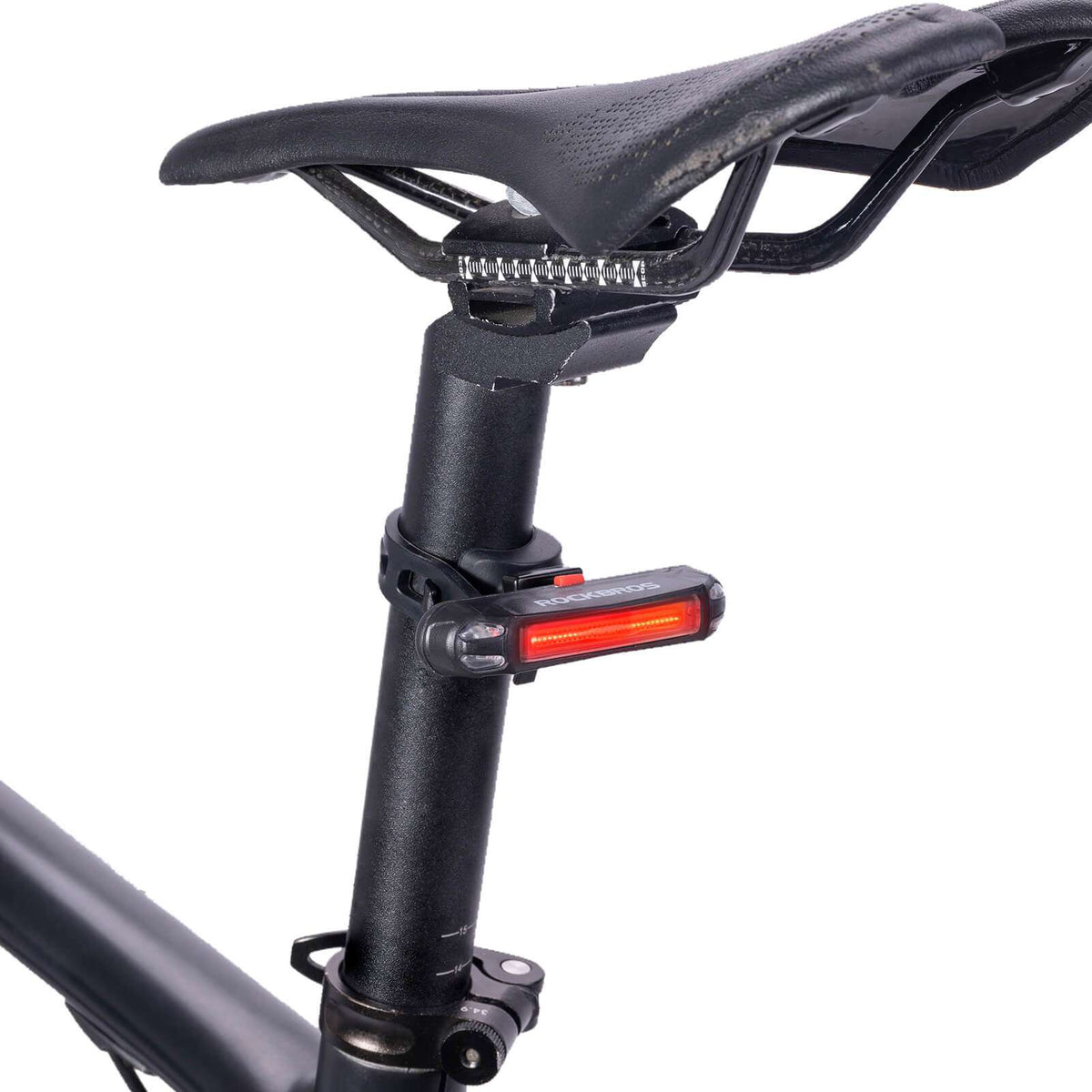 Rear bike light mounted on seatpost with horizontal bracket, red light bar