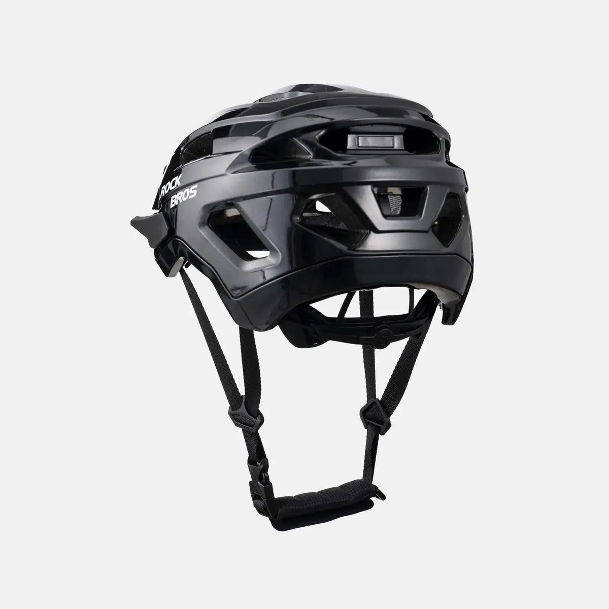 Black youth bike helmet side view with rear light-mount area and straps