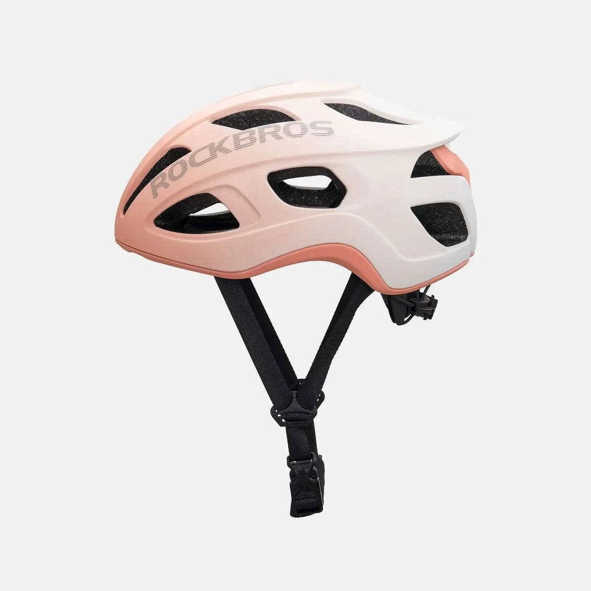 Lightweight bike helmet in matte pink, side view with vent openings and chin straps