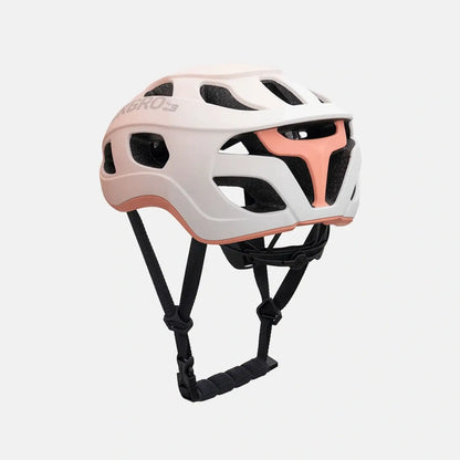 Lightweight bike helmet in matte pink, front three-quarter view with vent cutouts and straps