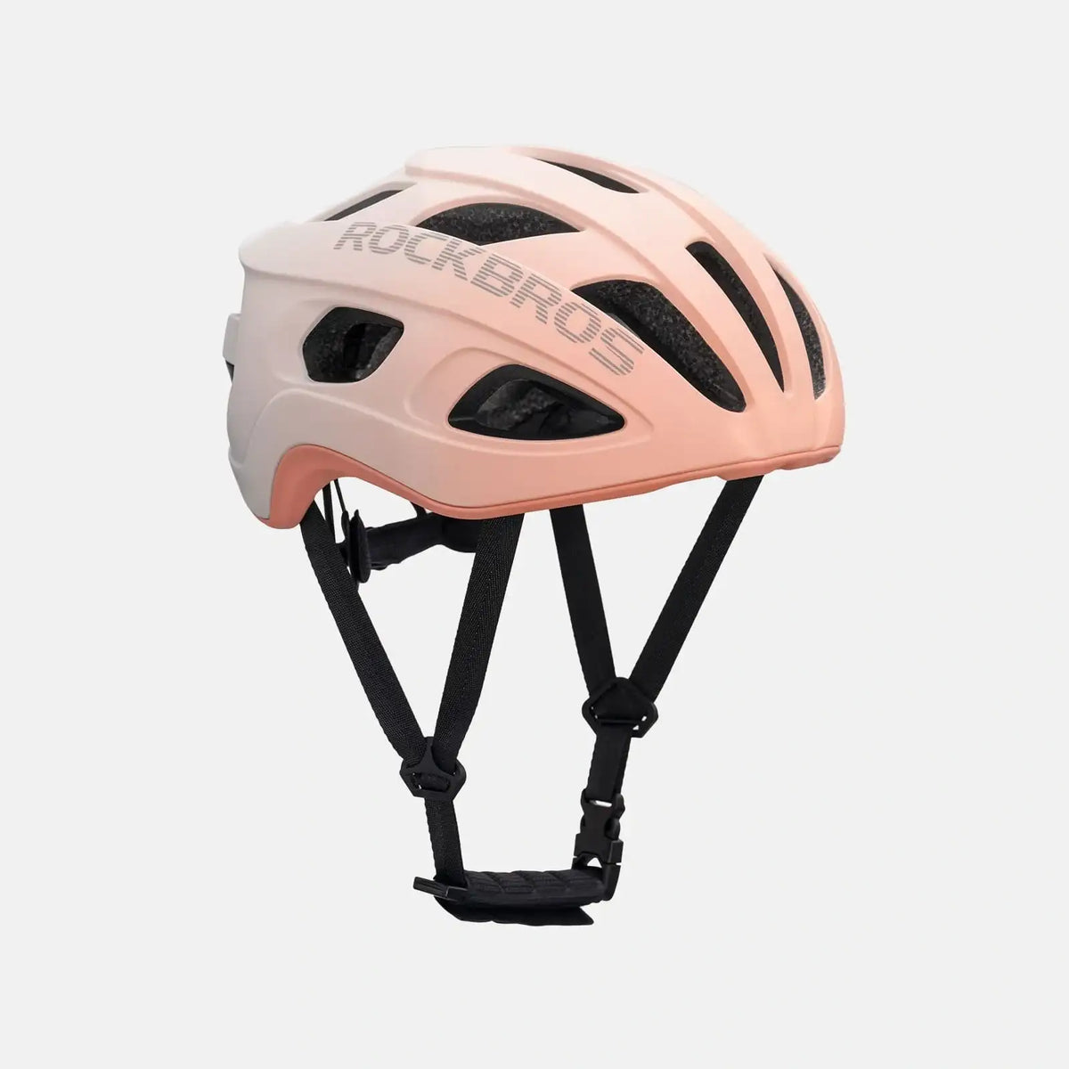 Lightweight bike helmet in matte pink, side profile with front vents and black chin straps