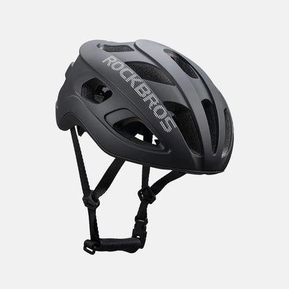 Lightweight bike helmet in matte black, side view with front vents and chin straps